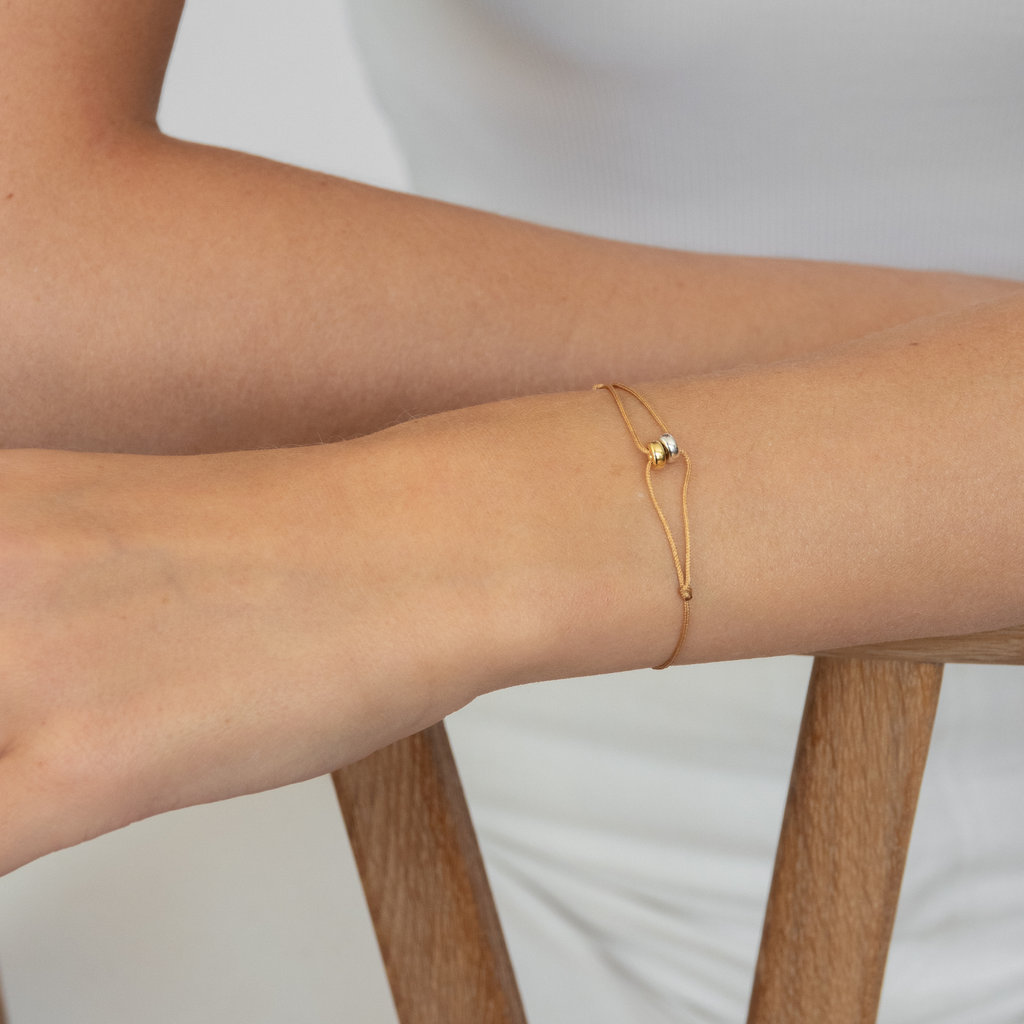 This bracelet is made of silk ribbon, recycled silver and plated with 18k thick gold.