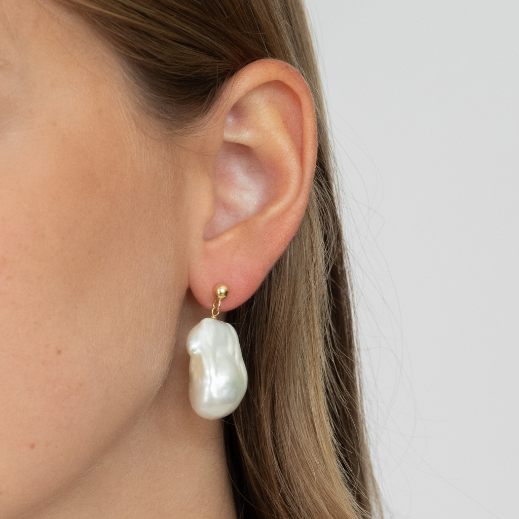 our Big Baroque Studs are the perfect classy, timeless statement earrings. made of responsibly sourced freshwater pearls and recycled 14k gold by the sustainable jewelry brand LLR Studios.